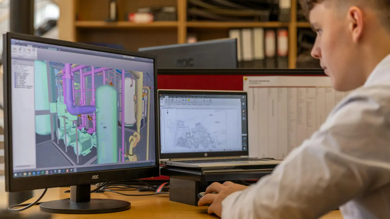 Consultant reviewing system architecture diagrams at desk